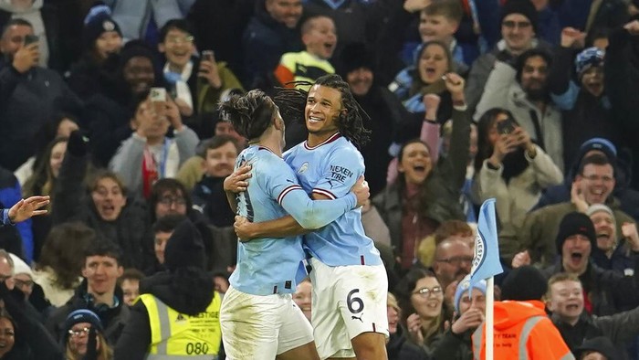 Manchester Citys Nathan Ake, right, celebrates with his teammate Jack Grealish after scoring his sides opening goal during the English FA Cup 4th round soccer match between Manchester City and Arsenal at the Etihad Stadium in Manchester, England, Friday, Jan. 27, 2023. (AP Photo/Dave Thompson)