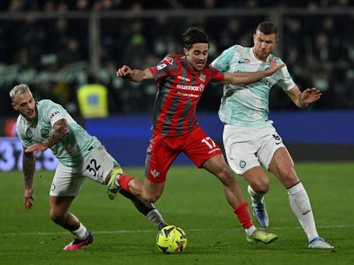 Cremoneses Italian defender Leonardo Sernicola fights for the ball with Inter Milans Italian defender Federico Dimarco and Inter Milans Bosnian forward Edin Dzeko during the Italian Serie A football match between Cremonese and Inter Milan on January 28, 2023 at the Giovanni Zini stadium in Cremona. (Photo by MIGUEL MEDINA / AFP)