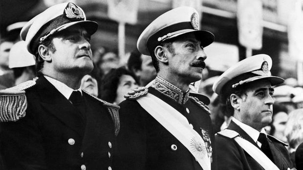 General Orlando Ramon Agosti (R), Commandant of Argentinian Air Force, Lieutenant General Jorge Rafael Videla (C), President of Argentina, and Admiral Emilio Massera (L) attend an official ceremony, Argentina, 1977. After leading the military coup that deposed Peron on 24 March 1976, Videla became President as head of three-man military junta including General Agosti and Admiral Massera. Videla retired in 1981 and was succeeded by General Roberto Viola. In 1985, Videla was convicted of murder and sentenced to life imprisonment in 1985, but was pardoned by President Menem in 1990. American sources reported 6,000 capital executions and from 12,000 to 17,000 people jailed since March 1976. (Photo by AFP)