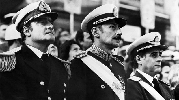 Junta militer Argentina 1976 General Orlando Ramon Agosti (R), Commandant of Argentinian Air Force, Lieutenant General Jorge Rafael Videla (C), President of Argentina, and Admiral Emilio Massera (L) attend an official ceremony, Argentina, 1977. After leading the military coup that deposed Peron on 24 March 1976, Videla became President as head of three-man military junta including General Agosti and Admiral Massera. Videla retired in 1981 and was succeeded by General Roberto Viola. In 1985, Videla was convicted of murder and sentenced to life imprisonment in 1985, but was pardoned by President Menem in 1990. American sources reported 6,000 capital executions and from 12,000 to 17,000 people jailed since March 1976. (Photo by AFP)
