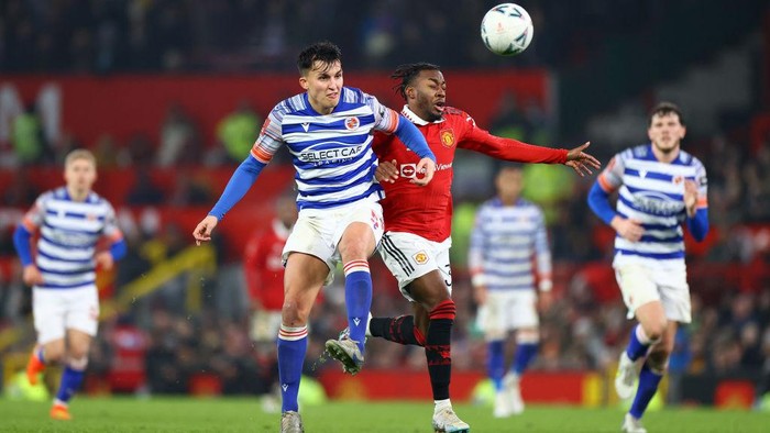 MANCHESTER, ENGLAND - JANUARY 28: Tom McIntyre of Reading battles for possession with Anthony Elanga of Manchester United during the Emirates FA Cup Fourth Round match between Manchester United and Reading at Old Trafford on January 28, 2023 in Manchester, England. (Photo by Michael Steele/Getty Images)