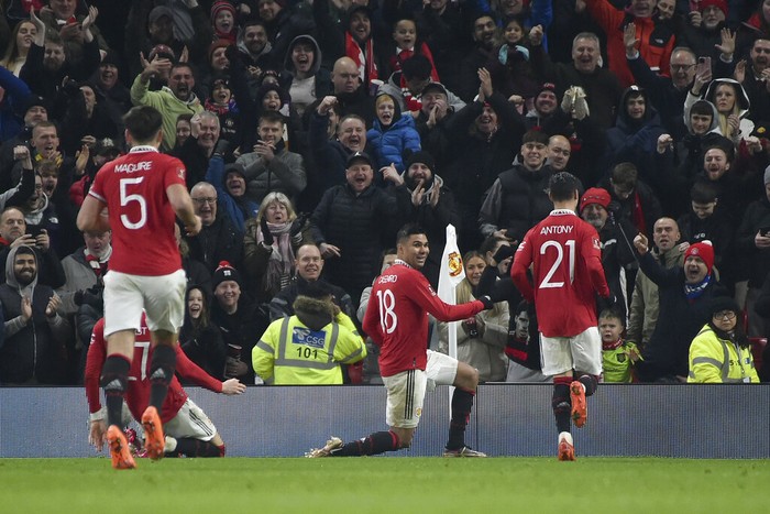 Manchester United's Casemiro, (18) celebrates with teammates after scoring his sides second goal of the game during the English FA Cup 4th round soccer match between Manchester United and Reading at Old Trafford in Manchester, England, Saturday, Jan. 28, 2023. (AP Photo/Rui Vieira)