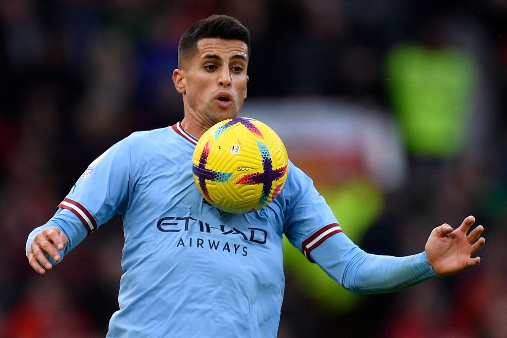 Manchester City's Portuguese defender Joao Cancelo controls the ball during the English Premier League football match between Manchester United and Manchester City at Old Trafford in Manchester, north west England, on January 14, 2023. - RESTRICTED TO EDITORIAL USE. No use with unauthorized audio, video, data, fixture lists, club/league logos or 'live' services. Online in-match use limited to 120 images. An additional 40 images may be used in extra time. No video emulation. Social media in-match use limited to 120 images. An additional 40 images may be used in extra time. No use in betting publications, games or single club/league/player publications. (Photo by Oli SCARFF / AFP) / RESTRICTED TO EDITORIAL USE. No use with unauthorized audio, video, data, fixture lists, club/league logos or 'live' services. Online in-match use limited to 120 images. An additional 40 images may be used in extra time. No video emulation. Social media in-match use limited to 120 images. An additional 40 images may be used in extra time. No use in betting publications, games or single club/league/player publications. / RESTRICTED TO EDITORIAL USE. No use with unauthorized audio, video, data, fixture lists, club/league logos or 'live' services. Online in-match use limited to 120 images. An additional 40 images may be used in extra time. No video emulation. Social media in-match use limited to 120 images. An additional 40 images may be used in extra time. No use in betting publications, games or single club/league/player publications. (Photo by OLI SCARFF/AFP via Getty Images)