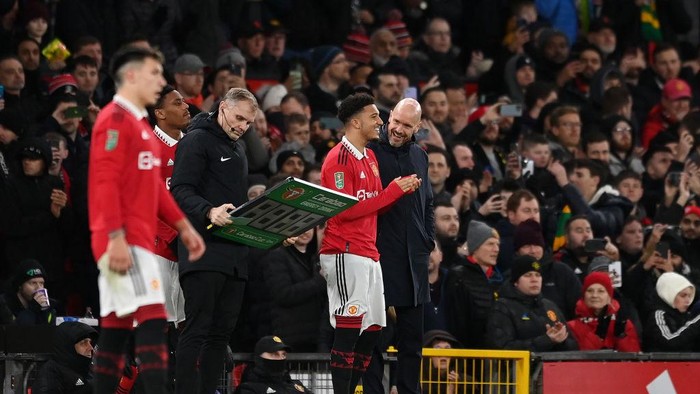 MANCHESTER, ENGLAND - FEBRUARY 01: Erik ten Hag speaks to Jadon Sancho of Manchester United before they are substituted on during the Carabao Cup Semi Final 2nd Leg match between Manchester United and Nottingham Forest at Old Trafford on February 01, 2023 in Manchester, England. (Photo by Michael Regan/Getty Images)