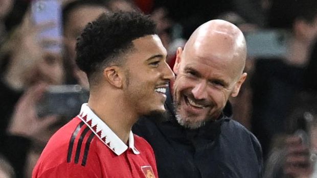 Manchester United's Dutch manager Erik ten Hag (R) talks with Manchester United's English striker Jadon Sancho as Sancho waits to be substituted on during the English League Cup semi-final second-leg  football match between Manchester United and Nottingham Forest at Old Trafford in Manchester, north west England, on February 1, 2023. - RESTRICTED TO EDITORIAL USE. No use with unauthorized audio, video, data, fixture lists, club/league logos or 'live' services. Online in-match use limited to 120 images. An additional 40 images may be used in extra time. No video emulation. Social media in-match use limited to 120 images. An additional 40 images may be used in extra time. No use in betting publications, games or single club/league/player publications. (Photo by Paul ELLIS / AFP) / RESTRICTED TO EDITORIAL USE. No use with unauthorized audio, video, data, fixture lists, club/league logos or 'live' services. Online in-match use limited to 120 images. An additional 40 images may be used in extra time. No video emulation. Social media in-match use limited to 120 images. An additional 40 images may be used in extra time. No use in betting publications, games or single club/league/player publications. / RESTRICTED TO EDITORIAL USE. No use with unauthorized audio, video, data, fixture lists, club/league logos or 'live' services. Online in-match use limited to 120 images. An additional 40 images may be used in extra time. No video emulation. Social media in-match use limited to 120 images. An additional 40 images may be used in extra time. No use in betting publications, games or single club/league/player publications. (Photo by PAUL ELLIS/AFP via Getty Images)