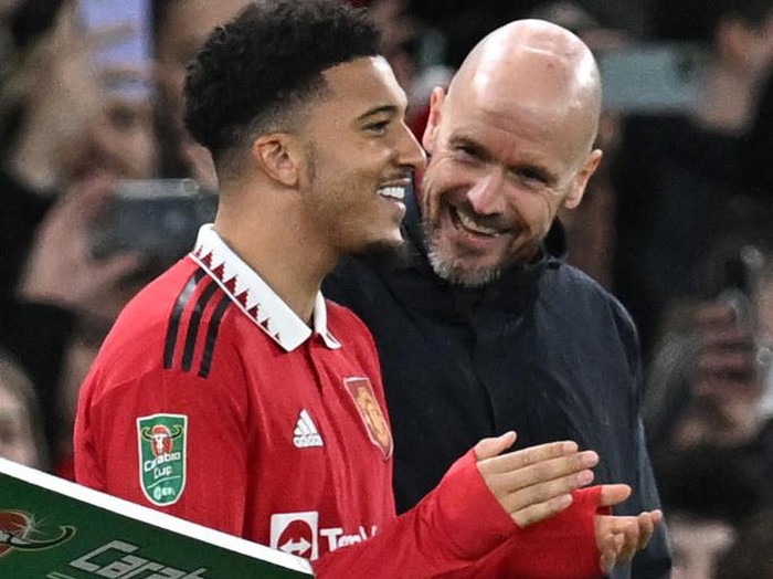 Manchester United's Dutch manager Erik ten Hag (R) talks with Manchester United's English striker Jadon Sancho as Sancho waits to be substituted on during the English League Cup semi-final second-leg  football match between Manchester United and Nottingham Forest at Old Trafford in Manchester, north west England, on February 1, 2023. - RESTRICTED TO EDITORIAL USE. No use with unauthorized audio, video, data, fixture lists, club/league logos or 'live' services. Online in-match use limited to 120 images. An additional 40 images may be used in extra time. No video emulation. Social media in-match use limited to 120 images. An additional 40 images may be used in extra time. No use in betting publications, games or single club/league/player publications. (Photo by Paul ELLIS / AFP) / RESTRICTED TO EDITORIAL USE. No use with unauthorized audio, video, data, fixture lists, club/league logos or 'live' services. Online in-match use limited to 120 images. An additional 40 images may be used in extra time. No video emulation. Social media in-match use limited to 120 images. An additional 40 images may be used in extra time. No use in betting publications, games or single club/league/player publications. / RESTRICTED TO EDITORIAL USE. No use with unauthorized audio, video, data, fixture lists, club/league logos or 'live' services. Online in-match use limited to 120 images. An additional 40 images may be used in extra time. No video emulation. Social media in-match use limited to 120 images. An additional 40 images may be used in extra time. No use in betting publications, games or single club/league/player publications. (Photo by PAUL ELLIS/AFP via Getty Images)
