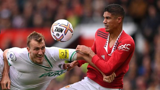 MANCHESTER, ENGLAND - OCTOBER 16: Newcastle United defender Dan Burn has his shirt pulled by Manchester United defender Raphael Varane during the Premier League match between Manchester United and Newcastle United at Old Trafford on October 15, 2022 in Manchester, England. (Photo by Stu Forster/Getty Images)