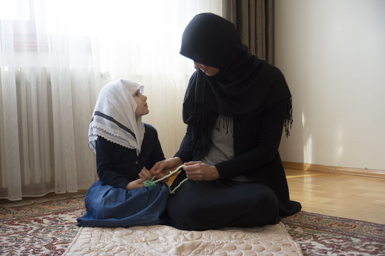 Little girl andher mother looking each other. Hicab woman and her daughter. aid mubarak