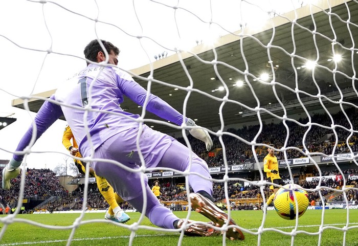 Liverpool goalkeeper Alisson Becker fails to stop teammate Joel Matip from scoring an own goal, during the English Premier League soccer match between Wolverhampton Wanderers and Liverpool, at Molineux Stadium, in Wolverhampton, England, Saturday, Feb. 4, 2023. (Tim Goode/PA via AP)