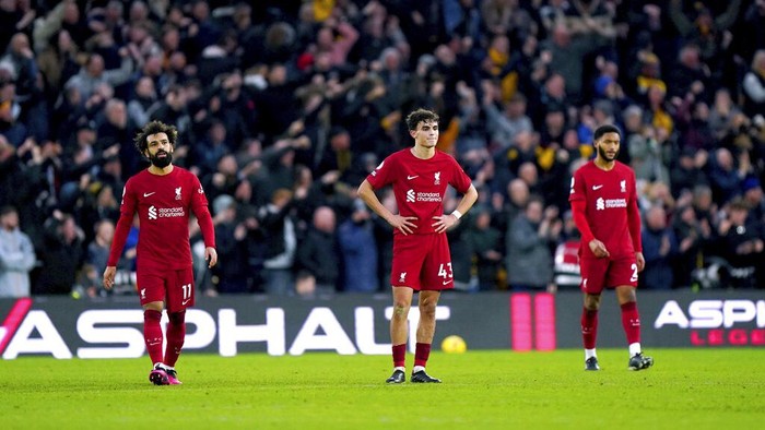 Liverpools Mohamad Salah, Stefan Bajcetic and Joe Gomez look on after Wolverhampton Wanderers Ruben Neves scores his sides third goal of the game, during the English Premier League soccer match between Wolverhampton Wanderers and Liverpool, at Molineux Stadium, in Wolverhampton, England, Saturday, Feb. 4, 2023. (Tim Goode/PA via AP)