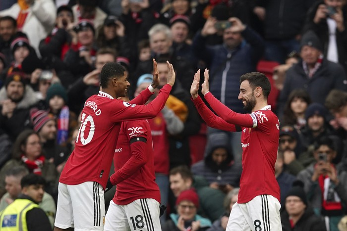 Manchester Uniteds Bruno Fernandes celebrates with teammates after scoring his sides opening goal during the English Premier League soccer match between Manchester United and Crystal Palace, at the Old Trafford stadium in Manchester, England, Saturday, Feb. 4, 2023. (AP Photo/Dave Thompson)