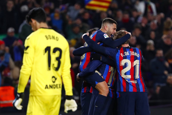 Barcelona's Jordi Alba, top, celebrates with his teammates after scoring his side's opening goal during a Spanish La Liga soccer match between Barcelona and Sevilla at the Camp Nou stadium in Barcelona, Spain, Sunday, Feb. 5, 2023. (AP Photo/Joan Monfort)