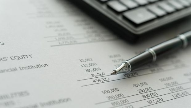 accounting business concept.  pen, calculator, financial statement on accountant's desk.