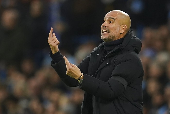 Manchester Citys head coach Pep Guardiola gestures during the English Premier League soccer match between Manchester City and Everton at the Etihad Stadium in Manchester, England, Saturday, Dec. 31, 2022. (AP Photo/Dave Thompson)