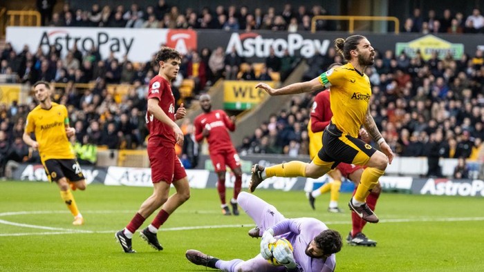 WOLVERHAMPTON, ENGLAND - FEBRUARY 04: Liverpools Alisson Becker saves under pressure from Wolverhampton Wanderers Ruben Neves during the Premier League match between Wolverhampton Wanderers and Liverpool FC at Molineux on February 04, 2023 in Wolverhampton, England. (Photo by Andrew Kearns - CameraSport via Getty Images)