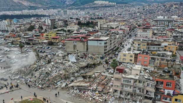 HATAY, TURKIYE - FEBRUARY 06: An aerial view of debris of a collapsed building after 7.7 magnitude earthquake hits Hatay, Turkiye on February 06, 2023. Disaster and Emergency Management Authority (AFAD) of Turkiye said the 7.7 magnitude quake struck at 4.17 a.m. (0117GMT) and was centered in the Pazarcik district in Turkiyeâs southern province of Kahramanmaras. Gaziantep, Sanliurfa, Diyarbakir, Adana, Adiyaman, Malatya, Osmaniye, Hatay, and Kilis provinces are heavily affected by the quake. (Photo by Murat Sengul/Anadolu Agency via Getty Images)
