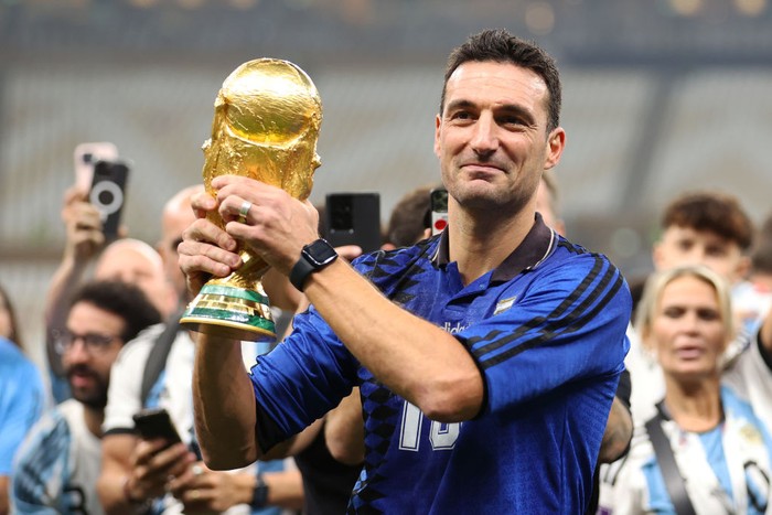 LUSAIL CITY, QATAR - DECEMBER 18: Lionel Scaloni, Head Coach of Argentina, celebrates with the FIFA World Cup Qatar 2022 Winner's Trophy after the FIFA World Cup Qatar 2022 Final match between Argentina and France at Lusail Stadium on December 18, 2022 in Lusail City, Qatar. (Photo by Julian Finney/Getty Images)
