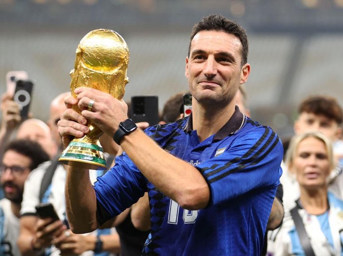 LUSAIL CITY, QATAR - DECEMBER 18: Lionel Scaloni, Head Coach of Argentina, celebrates with the FIFA World Cup Qatar 2022 Winner's Trophy after the FIFA World Cup Qatar 2022 Final match between Argentina and France at Lusail Stadium on December 18, 2022 in Lusail City, Qatar. (Photo by Julian Finney/Getty Images)
