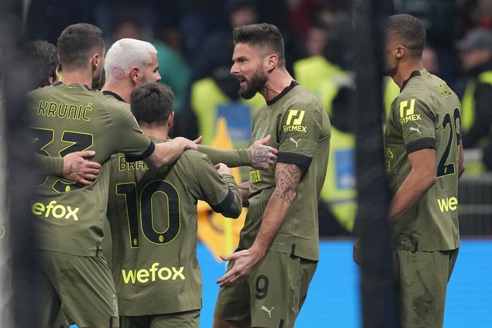 AC Milans Olivier Giroud, centre, celebrates after scoring his sides opening goal during the Italian Serie A soccer match between AC Milan and Torino at the San Siro stadium in Milan, Italy, Saturday, Feb. 10, 2023. (AP Photo/Antonio Calanni)