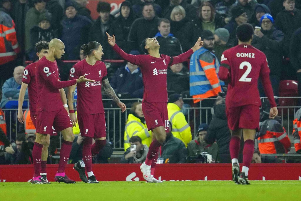 Liverpool's Cody Gakpo, centre, celebrates after scoring his side's second goal during the English Premier League soccer match between Liverpool and Everton at the Anfield stadium in Liverpool, England, Monday, Feb. 13, 2023. (AP Photo/Jon Super)