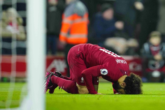 Liverpool's Mohamed Salah celebrates after scoring his side's opening goal during the English Premier League soccer match between Liverpool and Everton at the Anfield stadium in Liverpool, England, Monday, Feb. 13, 2023. (AP Photo/Jon Super)