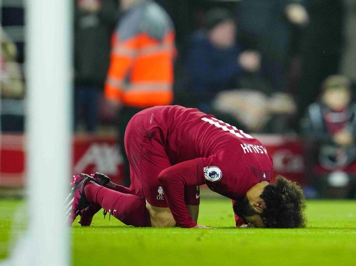 Liverpool's Mohamed Salah celebrates after scoring his side's opening goal during the English Premier League soccer match between Liverpool and Everton at the Anfield stadium in Liverpool, England, Monday, Feb. 13, 2023. (AP Photo/Jon Super)