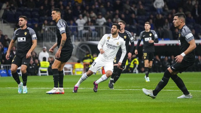 Real Madrids Marco Asensio, center, reacts after scoring his sides opening goal during Spanish La Liga soccer match between Real Madrid and Elche CF at the Santiago Bernabeu stadium in Madrid, Spain, Wednesday, Feb. 15, 2023. (AP Photo/Manu Fernandez)