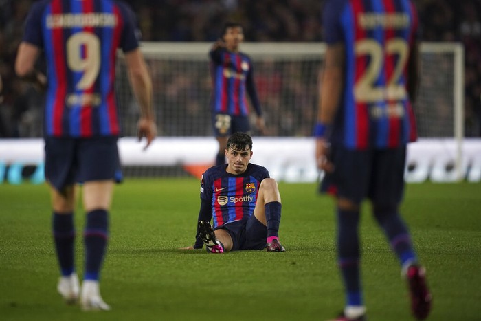 Barcelona's Pedri is seen on the ground during the Europa League playoff first leg soccer match between Barcelona and Manchester United at the Camp Nou stadium in Barcelona, Spain, Thursday, Feb. 16, 2023. (AP Photo/Joan Mateu Parra)