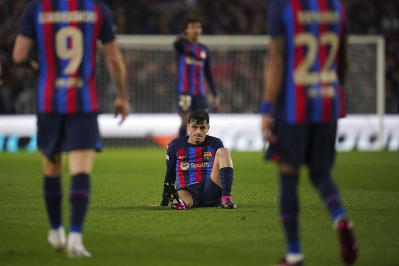 Barcelona's Pedri is seen on the ground during the Europa League playoff first leg soccer match between Barcelona and Manchester United at the Camp Nou stadium in Barcelona, Spain, Thursday, Feb. 16, 2023. (AP Photo/Joan Mateu Parra)