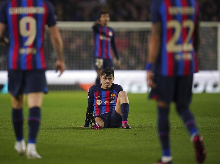 Barcelona's Pedri is seen on the ground during the Europa League playoff first leg soccer match between Barcelona and Manchester United at the Camp Nou stadium in Barcelona, Spain, Thursday, Feb. 16, 2023. (AP Photo/Joan Mateu Parra)