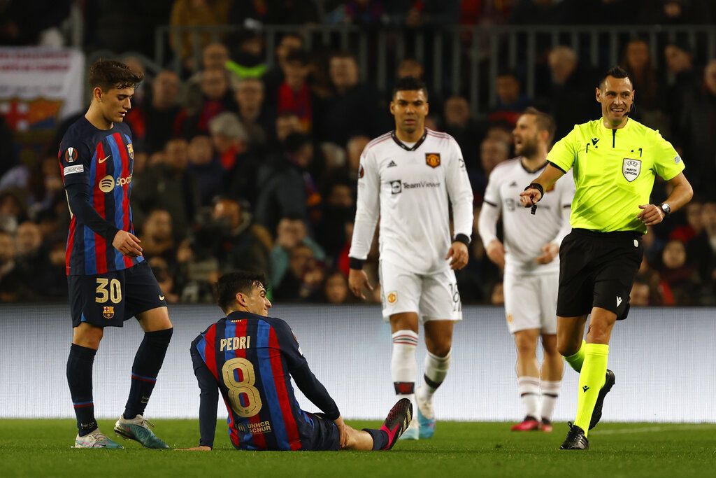 Barcelona's Pedri is seen on the ground during the Europa League playoff first leg soccer match between Barcelona and Manchester United at the Camp Nou stadium in Barcelona, Spain, Thursday, Feb. 16, 2023. (AP Photo/Joan Mateu Parra)