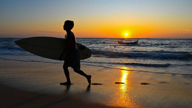 People enjoy the sunset at a beach cafe at Lhoknga, Indonesia's Aceh province on February 18, 2023. (Photo by CHAIDEER MAHYUDDIN / AFP) (Photo by CHAIDEER MAHYUDDIN/AFP via Getty Images)