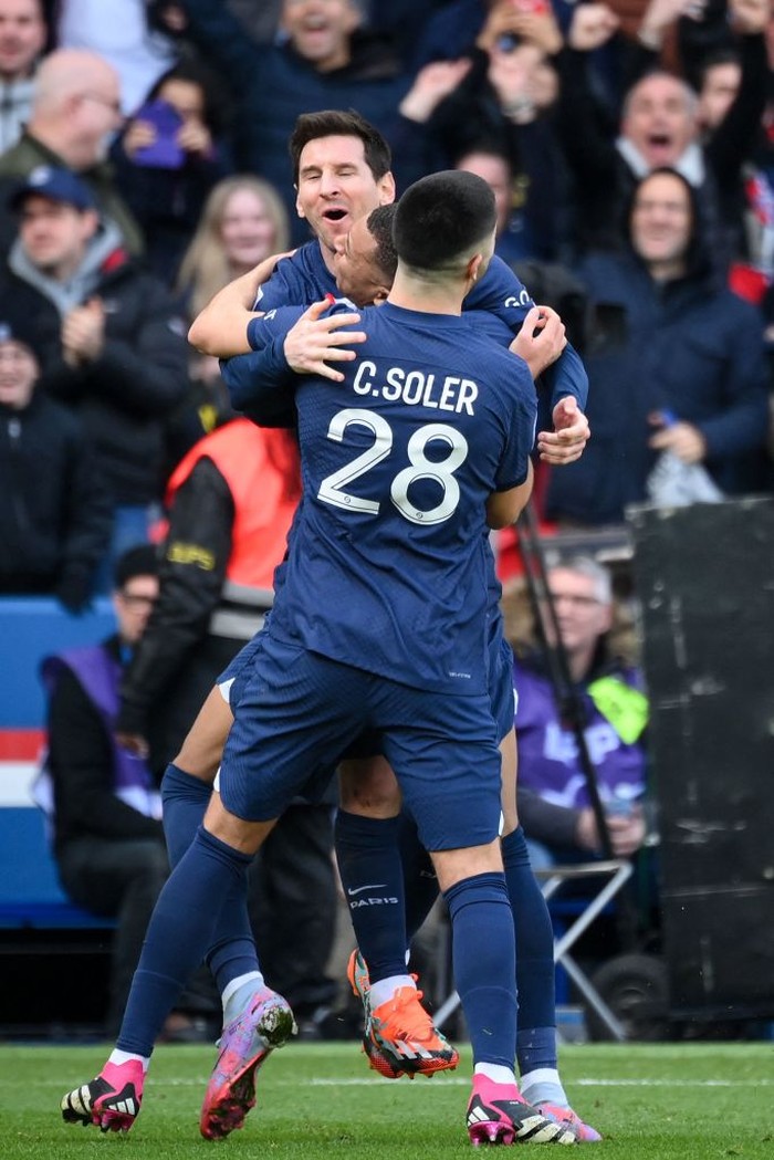 Paris Saint-Germain's Argentine forward Lionel Messi (C) celebrates with Paris Saint-Germain's Spanish midfielder Carlos Soler after scoring his team's fourth goal during the French L1 football match between Paris Saint-Germain (PSG) and Lille LOSC at The Parc des Princes Stadium in Paris on February 19, 2023. (Photo by FRANCK FIFE / AFP) (Photo by FRANCK FIFE/AFP via Getty Images)