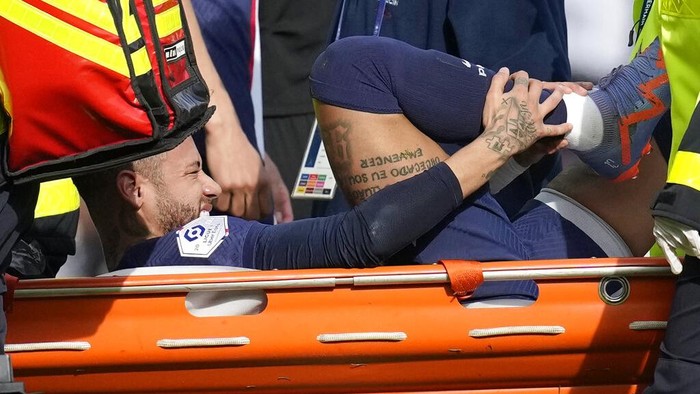 PSGs Neymar is carried off the field on a stretcher after after injuring during the French League One soccer match between Paris Saint-Germain and Lille at the Parc des Princes stadium, in Paris, France, Sunday, Feb. 19, 2023. (AP Photo/Christophe Ena)