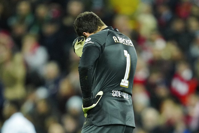 Liverpools goalkeeper Alisson gestures after Real Madrids Vinicius Junior scores his sides second goal during the Champions League, round of 16, first leg soccer match between Liverpool and Real Madrid at the Anfield stadium in Liverpool, England, Tuesday, Feb. 21, 2023. (AP Photo/Jon Super)