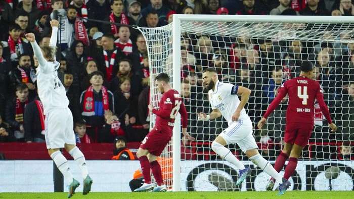 Real Madrids Karim Benzema, right, second right, celebrates after scoring his sides fifth goal during the Champions League, round of 16, first leg soccer match between Liverpool and Real Madrid at the Anfield stadium in Liverpool, England, Tuesday, Feb. 21, 2023. (AP Photo/Jon Super)