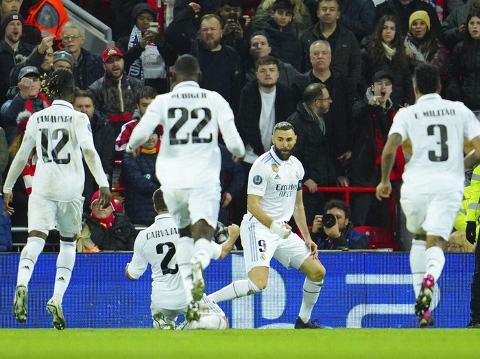 Real Madrid's Karim Benzema, second right, celebrates after scoring his side's fourth goal during the Champions League, round of 16, first leg soccer match between Liverpool and Real Madrid at the Anfield stadium in Liverpool, England, Tuesday, Feb. 21, 2023. (AP Photo/Jon Super)
