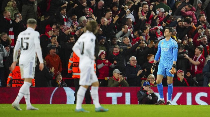 Real Madrids goalkeeper Thibaut Courtois, right, gestures after Liverpools Mohamed Salah scores his sides second goal during the Champions League, round of 16, first leg soccer match between Liverpool and Real Madrid at the Anfield stadium in Liverpool, England, Tuesday, Feb. 21, 2023. (AP Photo/Jon Super)