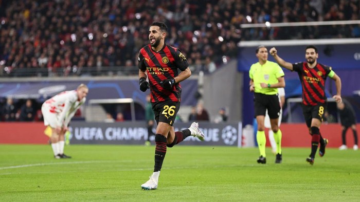 LEIPZIG, GERMANY - FEBRUARY 22: Riyad Mahrez of Manchester City celebrates after scoring the teams first goal during the UEFA Champions League round of 16 leg one match between RB Leipzig and Manchester City at Red Bull Arena on February 22, 2023 in Leipzig, Germany. (Photo by Lars Baron/Getty Images)