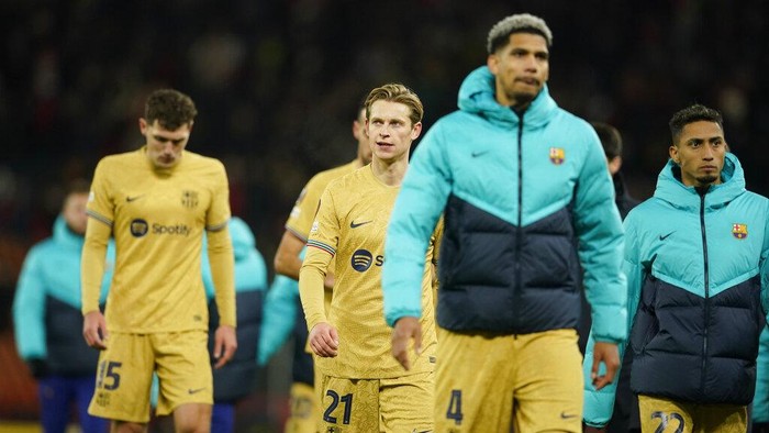 Barcelona players walk off the field at the end of the Europa League playoff second leg soccer match between Manchester United and Barcelona at Old Trafford stadium in Manchester, England, Thursday, Feb. 23, 2023. Manchester United won 2-1. (AP Photo/Dave Thompson)