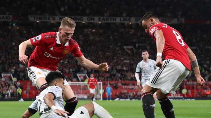 MANCHESTER, ENGLAND - AUGUST 22: Scott McTominay of Manchester United in action with Luis Díaz of Liverpool during the Premier League match between Manchester United and Liverpool FC at Old Trafford on August 22, 2022 in Manchester, England. (Photo by Tom Purslow/Manchester United via Getty Images)