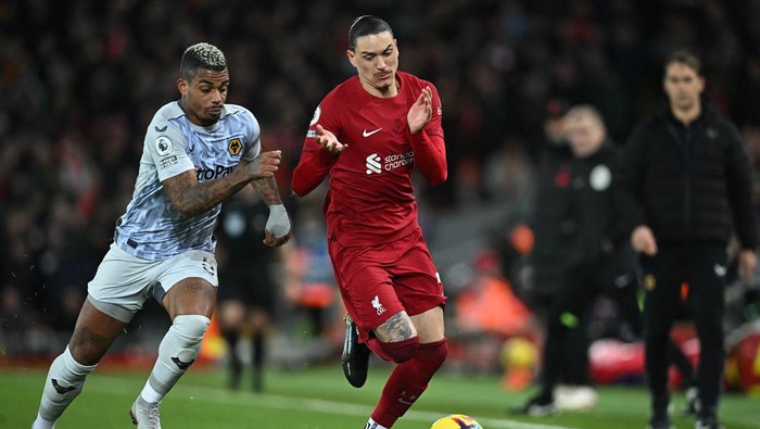 Wolverhampton Wanderers Gabonese midfielder Mario Lemina (L) vies with Liverpools Uruguayan striker Darwin Nunez during the English Premier League football match between Liverpool and Wolverhampton at Anfield in Liverpool, north west England on March 1, 2023. (Photo by Paul ELLIS / AFP) / RESTRICTED TO EDITORIAL USE. No use with unauthorized audio, video, data, fixture lists, club/league logos or live services. Online in-match use limited to 120 images. An additional 40 images may be used in extra time. No video emulation. Social media in-match use limited to 120 images. An additional 40 images may be used in extra time. No use in betting publications, games or single club/league/player publications. /  (Photo by PAUL ELLIS/AFP via Getty Images)