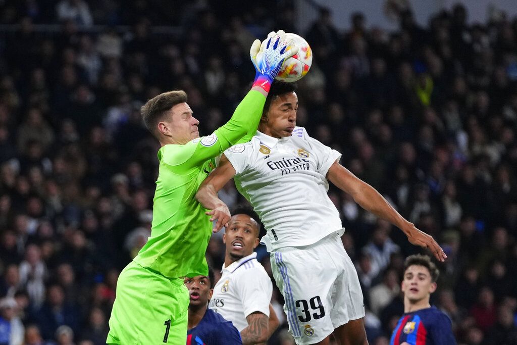 Barcelona's goalkeeper Marc-Andre ter Stegen, left, makes a save in front of Real Madrid's Alvaro during the Spanish Copa del Rey semi final, first leg soccer match between Real Madrid and Barcelona at Santiago Bernabeu stadium in Madrid, Spain, Thursday, March 2, 2023. (AP Photo/Manu Fernandez)