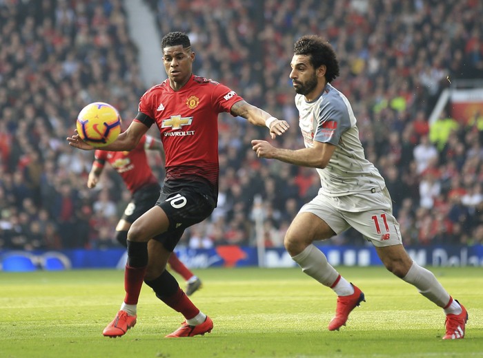 Manchester Uniteds Marcus Rashford, left, and Liverpools Mohamed Salah challenge for the ball during the English Premier League soccer match between Manchester United and Liverpool at Old Trafford stadium in Manchester, England, Sunday, Feb. 24, 2019. (AP Photo/Jon Super)