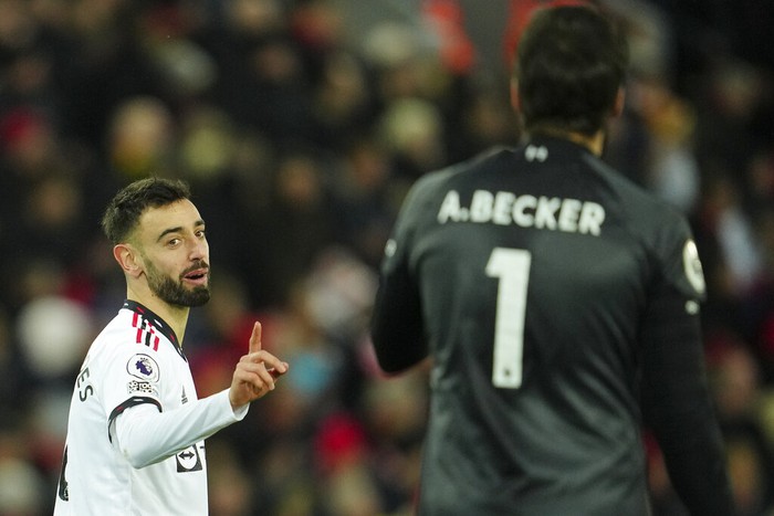 Manchester Uniteds Bruno Fernandes gestures towards Liverpools goalkeeper Alisson during the English Premier League soccer match between Liverpool and Manchester United at Anfield in Liverpool, England, Sunday, March 5, 2023. (AP Photo/Jon Super)