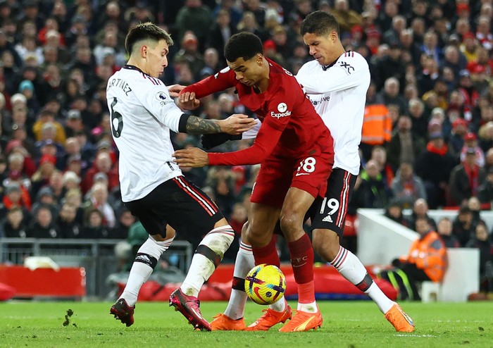 Soccer Football - Premier League - Liverpool v Manchester United - Anfield, Liverpool, Britain - March 5, 2023 Liverpools Cody Gakpo in action with Manchester Uniteds Lisandro Martinez and Raphael Varane REUTERS/Carl Recine EDITORIAL USE ONLY. No use with unauthorized audio, video, data, fixture lists, club/league logos or live services. Online in-match use limited to 75 images, no video emulation. No use in betting, games or single club /league/player publications.  Please contact your account representative for further details.