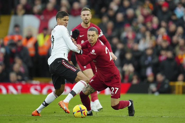 Manchester Uniteds Raphael Varane, left, challenges Liverpools Darwin Nunez during the English Premier League soccer match between Liverpool and Manchester United at Anfield in Liverpool, England, Sunday, March 5, 2023. (AP Photo/Jon Super)