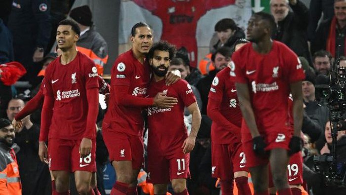 Liverpools Egyptian striker Mohamed Salah (C) celebrates with teammates after scoring their fourth goal during the English Premier League football match between Liverpool and Manchester United at Anfield in Liverpool, north west England on March 5, 2023. (Photo by Paul ELLIS / AFP) / RESTRICTED TO EDITORIAL USE. No use with unauthorized audio, video, data, fixture lists, club/league logos or live services. Online in-match use limited to 120 images. An additional 40 images may be used in extra time. No video emulation. Social media in-match use limited to 120 images. An additional 40 images may be used in extra time. No use in betting publications, games or single club/league/player publications. /  (Photo by PAUL ELLIS/AFP via Getty Images)