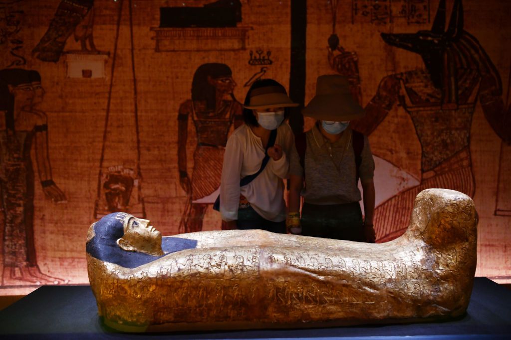 CHENGDU, CHINA - AUGUST 18: Visitors view a golden mummy during the 