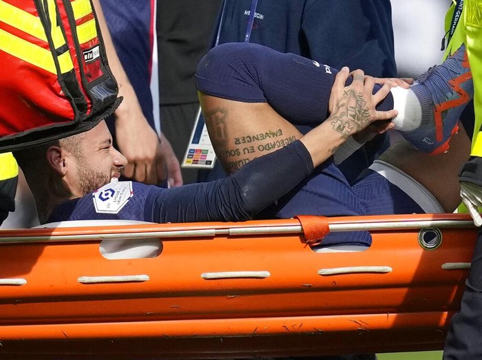 PSG's Neymar is carried off the field on a stretcher after after injuring during the French League One soccer match between Paris Saint-Germain and Lille at the Parc des Princes stadium, in Paris, France, Sunday, Feb. 19, 2023. (AP Photo/Christophe Ena)